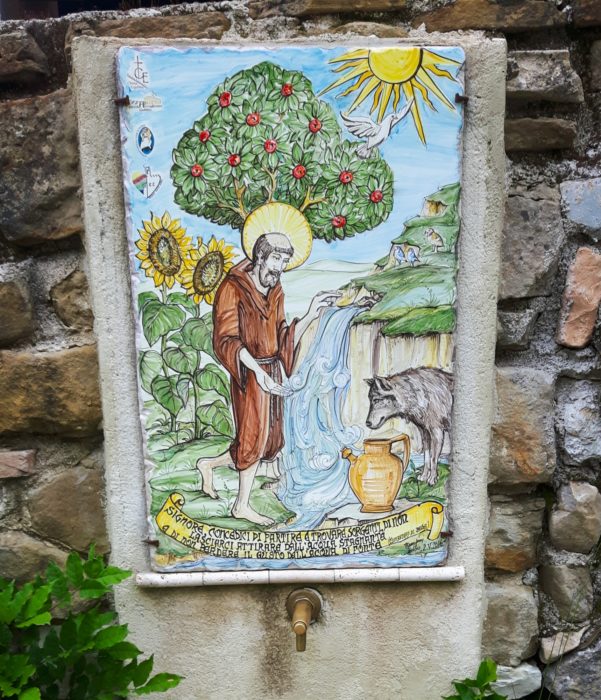Fountain with painting of St Francis and the wolf (during his stay in the town of Gubbio Francis was said to have tamed a wolf that was raiding towns and farmsteads).