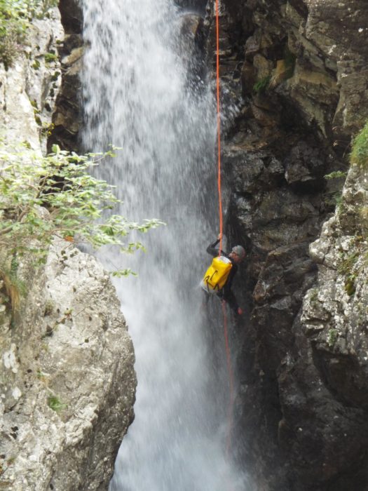 Abseiing down waterfall on the Río Calderés