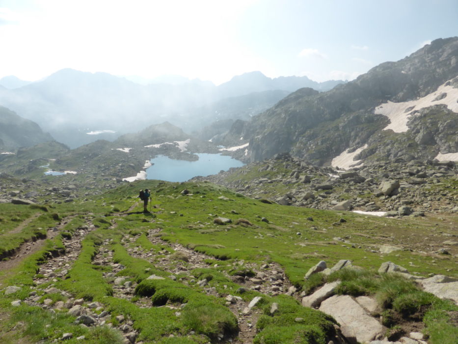 A lone walker taking photos into the mist
