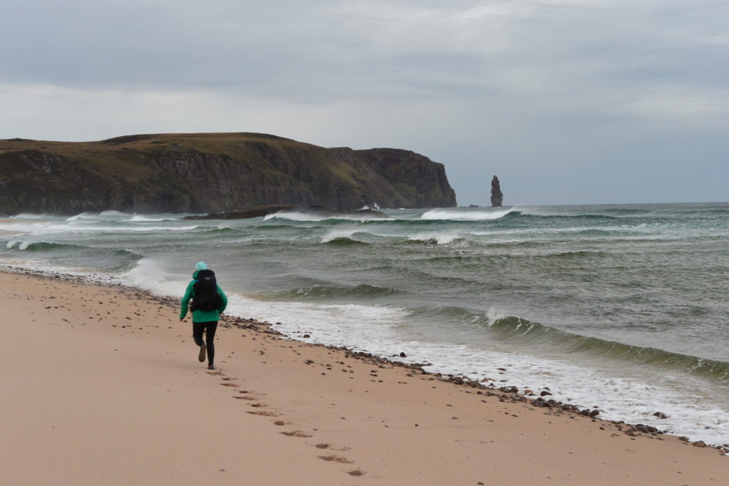 Lily running through Sandwood Bay, Scotland. Photo by Chris Councell.