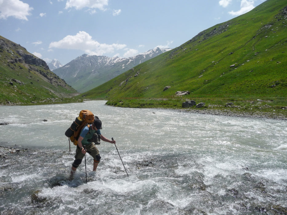 Deeper into the Tajik mountains trekkers can expect multiple river crossings and sometimes have to wait for water levels to drop. Here co-author of the Cicerone guide Trekking in Tajikistan Jan Bakker crosses a tributary of the Yagnob River.