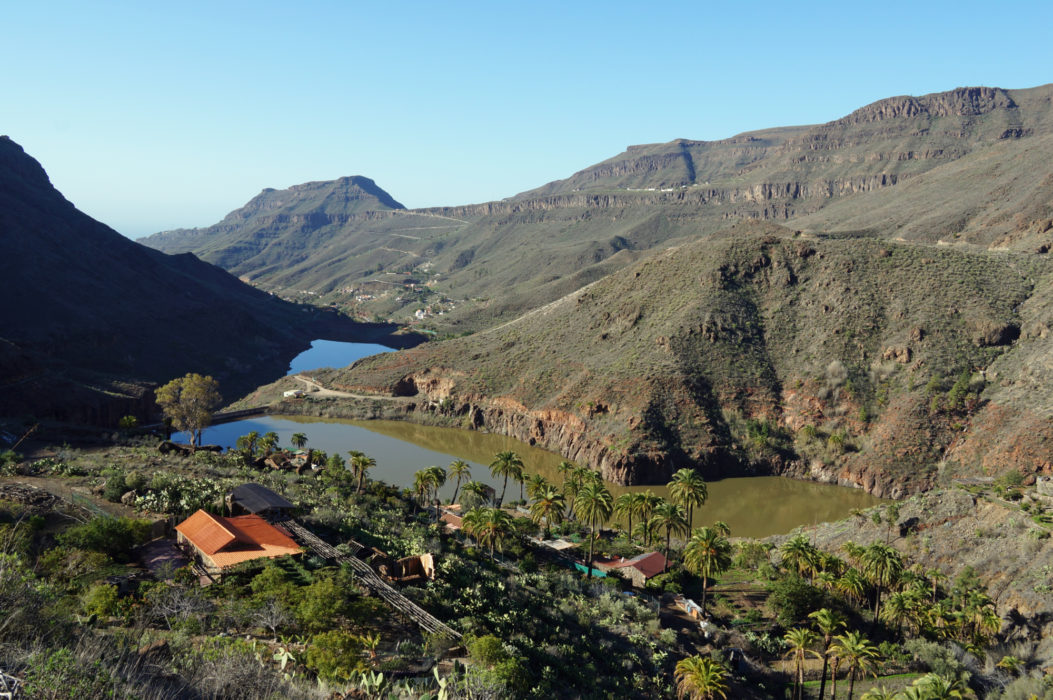 Looking back across two reservoirs to the village of Ayagaures