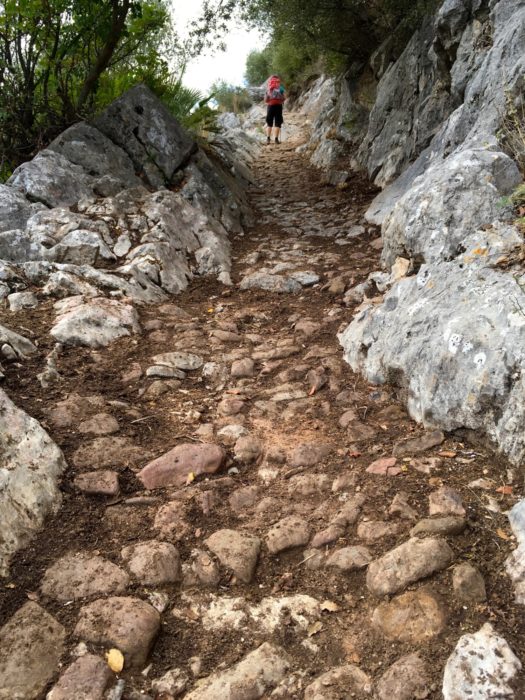 An ancient cobbled path leads into the hills