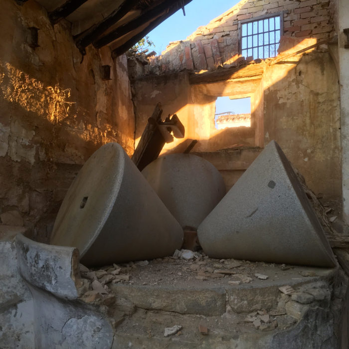 Olive millstones in a crumbling cortijo