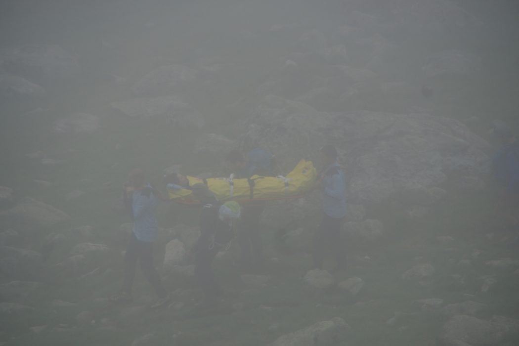 Carrying the unfortunate victim down on a stretcher