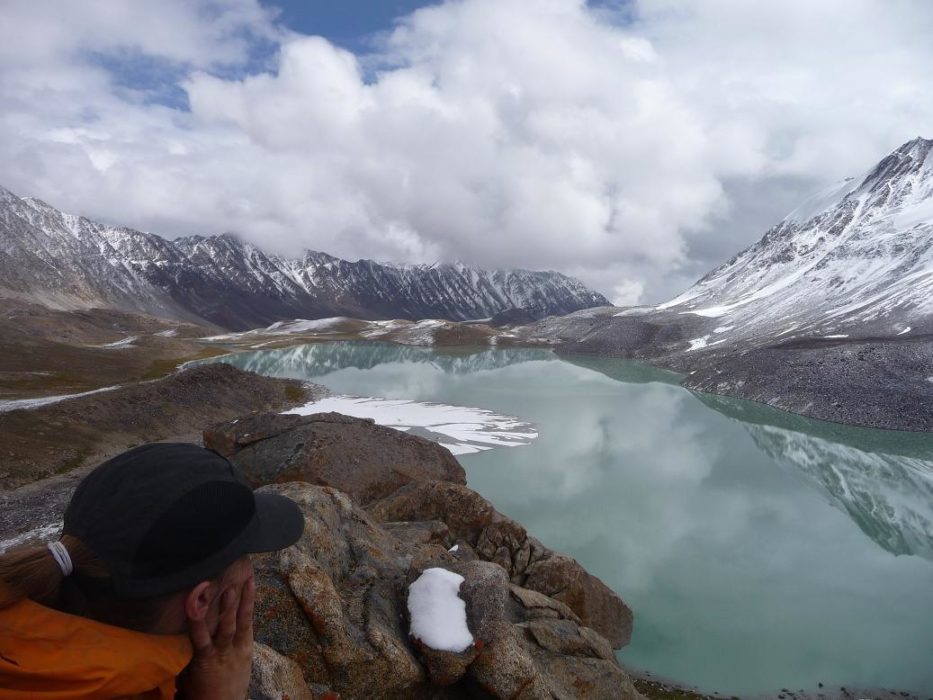 Still waters: admiring an alpine lake, high up in the Afghan Pamirs