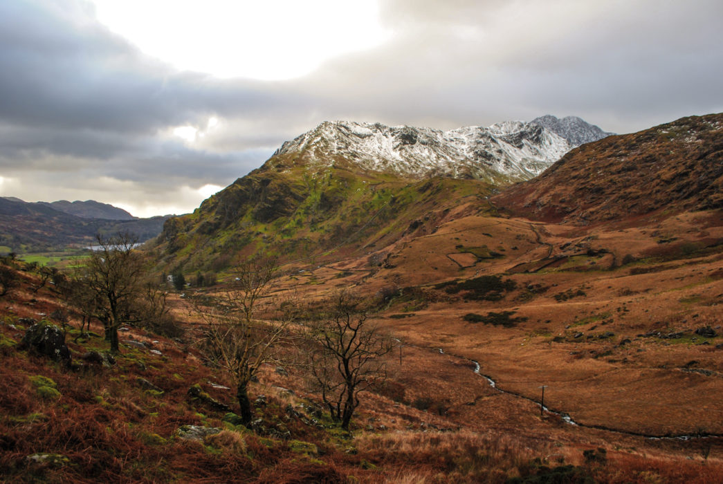 The Snow Covered Peak Of Y Lliwedd Rising Above Nant Gwynant