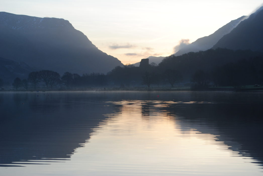 Dolbadarn Castle Seen Across A Serene Llyn Padarn