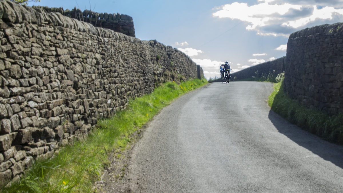 Riding between high stone walls in the Pennines
