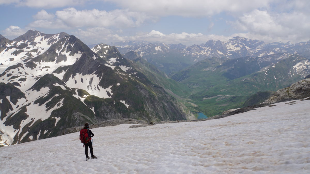 Descending on the glacier with Lac du Barrage d’Ossoue below and the Cirque de Gavarnie peaks in the distance