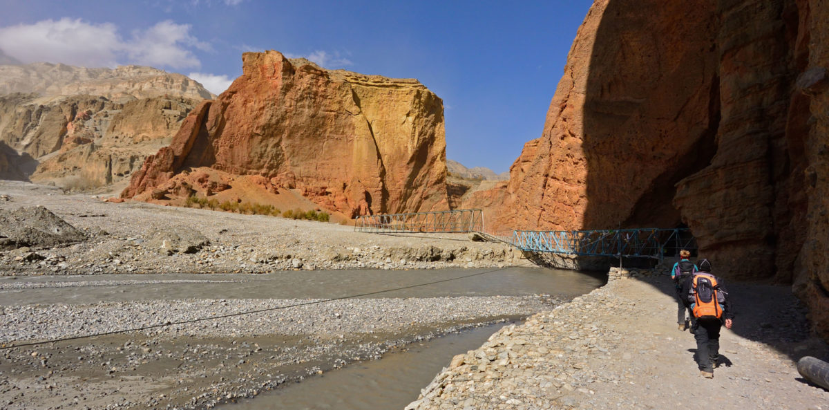Crossing an iron bridge over the Kali Ghandaki brings us back to the Peissel book