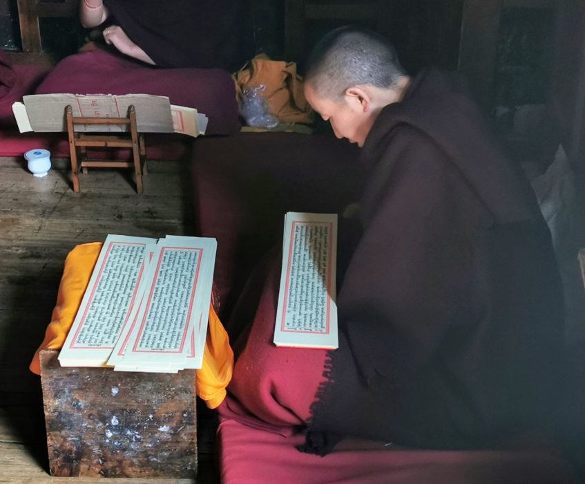 A monk reading prayers at Thubtan Chholing Monastery in Junbesi