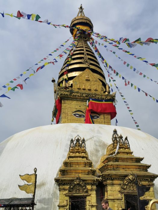 A stupa in Kathmandu. You can purchase buckets of white paint as an offering and these are then thrown over the stupa from the top of the dome.