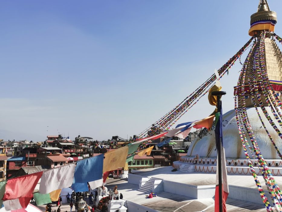 Prayer flags draped from a stupa