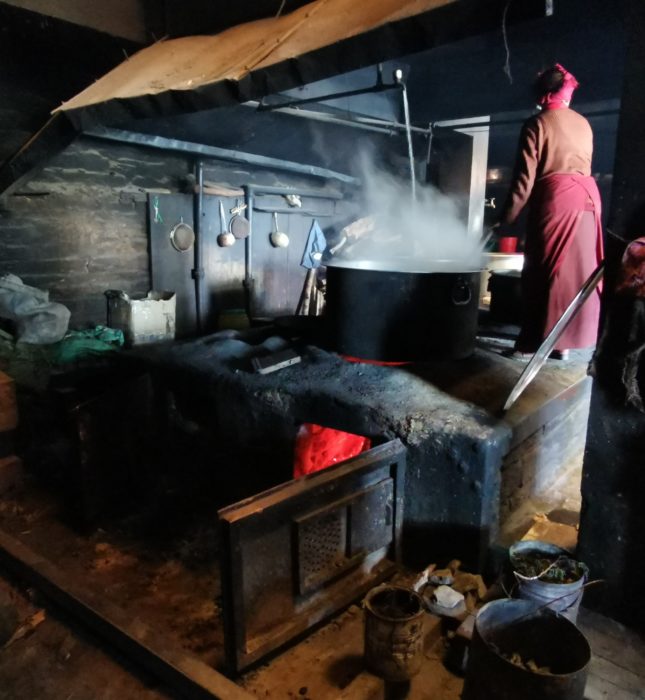 We were invited into the monastery's kitchen for a cup of salt butter tea. Cooking dhal bat for the residents requires a massive pan!