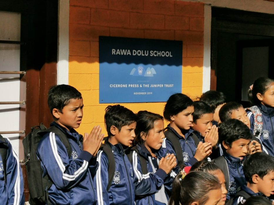 A group photo in front of the finished school