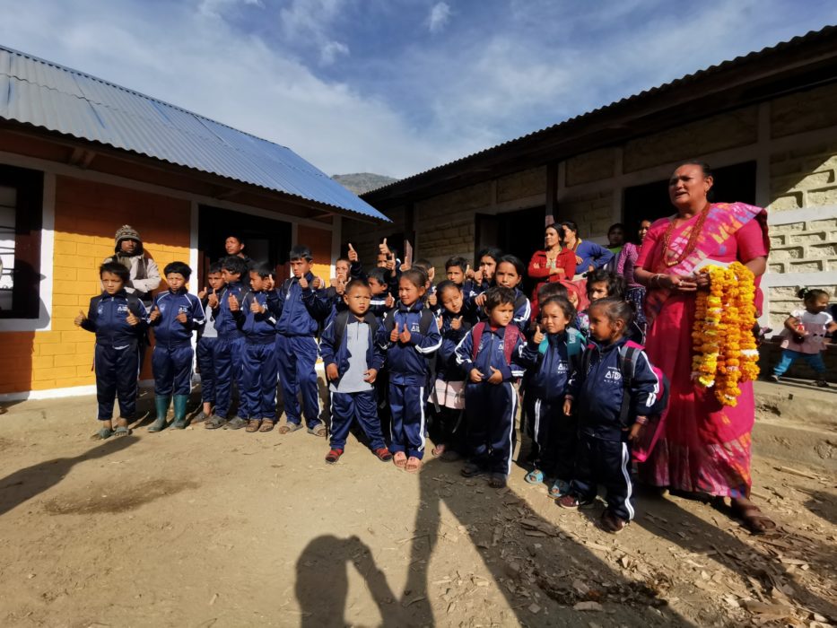 A group photo in front of the finished school