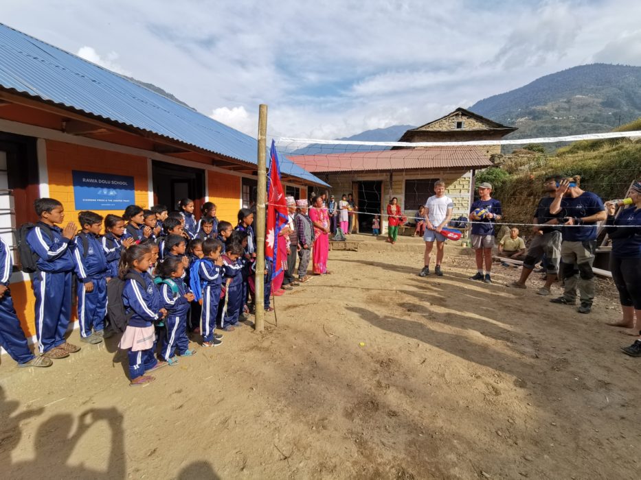 A group photo in front of the finished school