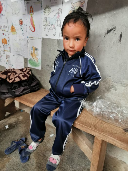 One of the children at Kinja wearing their new uniform